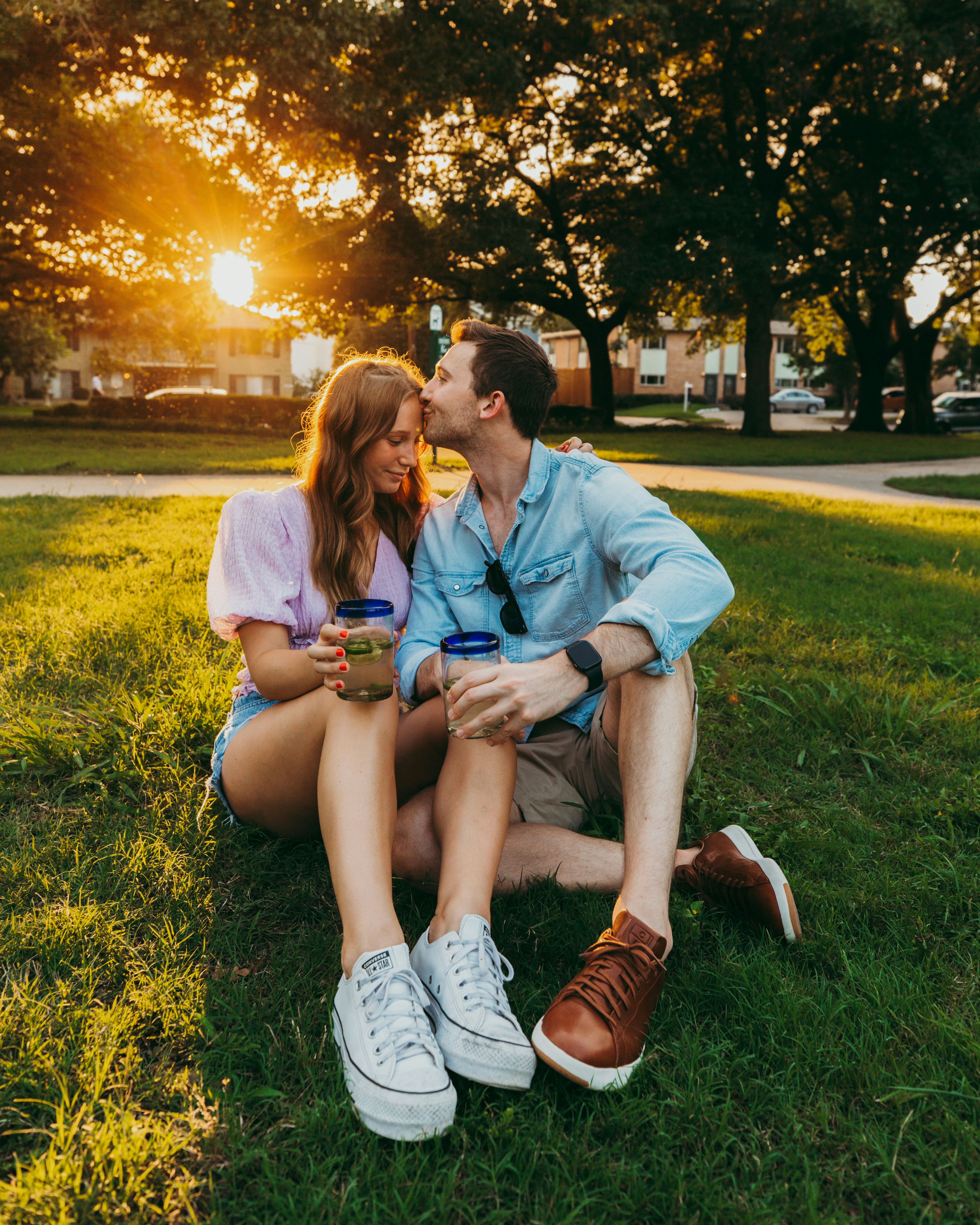 man and woman sitting on green grass field during daytime